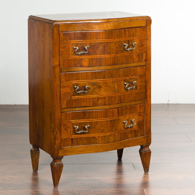 A Italian petite walnut three-drawer chest from the early 19th century, with banding and tapered feet. Created in Italy...