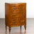 A Italian petite walnut three-drawer chest from the early 19th century, with banding and tapered feet. Created in Italy...