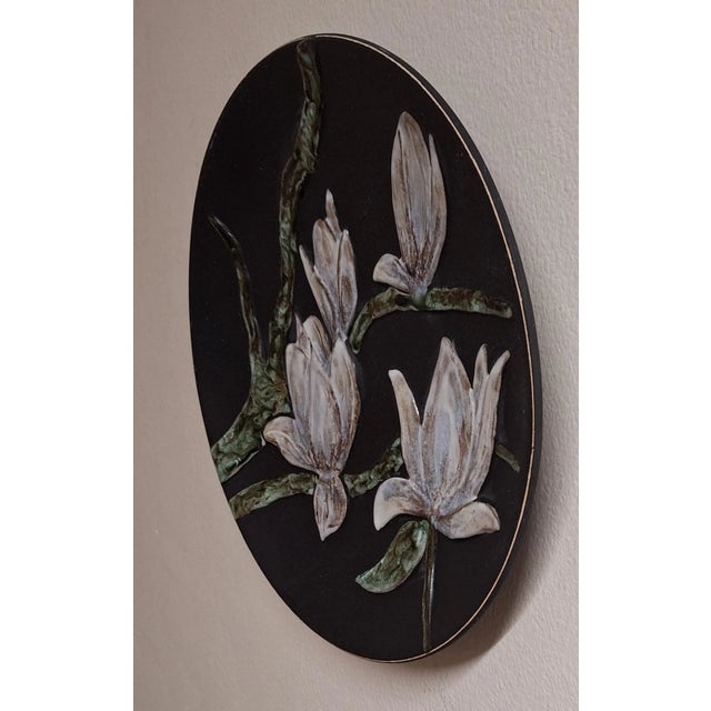 German Wall Plate in Ceramic with Glazed Colored Magnolia Blossoms, 1970s, in Very Good conditions. Designed 1970 to 1979