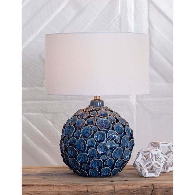 Organically shaped and glazed in various tones the Lucia lamp is reminiscent of the beach. Multiple hand-crafted, pinched...