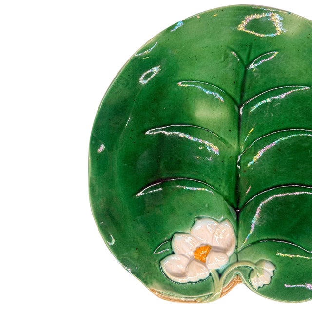 George Jones Majolica Waterlily pad plate glazed in Lush greens, with a relief-molded lily flower; marks to reverse: 'GJ'...