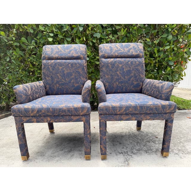 A pair of Mastercraft Parsons style armchairs featuring a clean, tailored silhouette with integrated arms and solid brass...