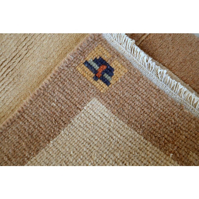 This handmade vintage Tibetan Khaden rug from the 1960s embodies the understated elegance and quiet sophistication...