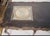 A dramatic 66-inch statement table combining French-inspired curves, distressed black paint and jewel-like gilt and...