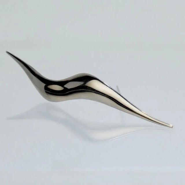 Offered here for your consideration is a stainless steel brooch. By the American Modernist Jose De Rivera. In a stylized...