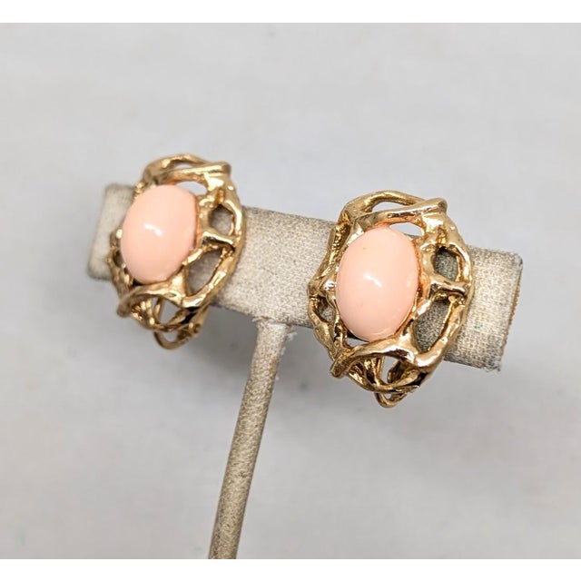 Modernist openwork faux-coral cabochon clip and screw back earrings. Marked "Napier." Date to 1973. Measure: 1 inch long...