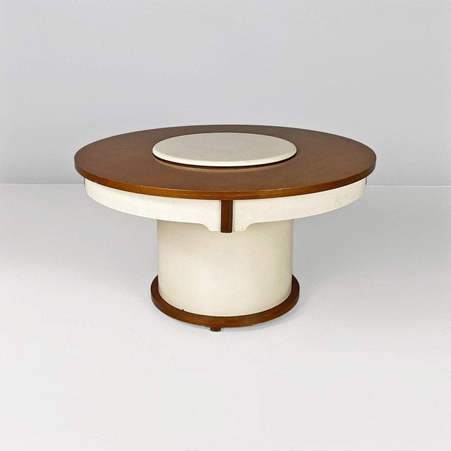 Coffee table, also known as Gervasino table, with wooden frame in natural color, with parts painted white. The white disk...