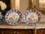 An antique Japanese Meiji pair of Imari porcelain plates, finely hand painted with exotic birds, flowering peonies and...