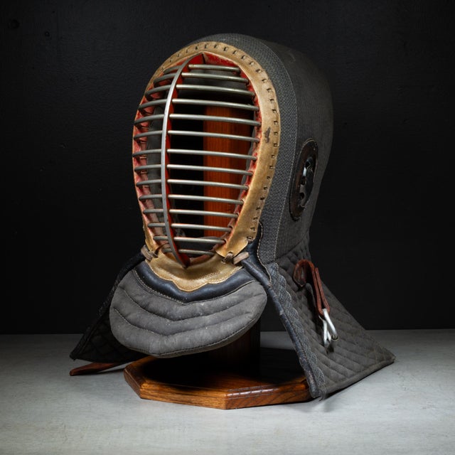 ABOUT An authentic vintage KuSakura Japanese Kendo armor mask with red and silver steel face guard surrounded by leather,...