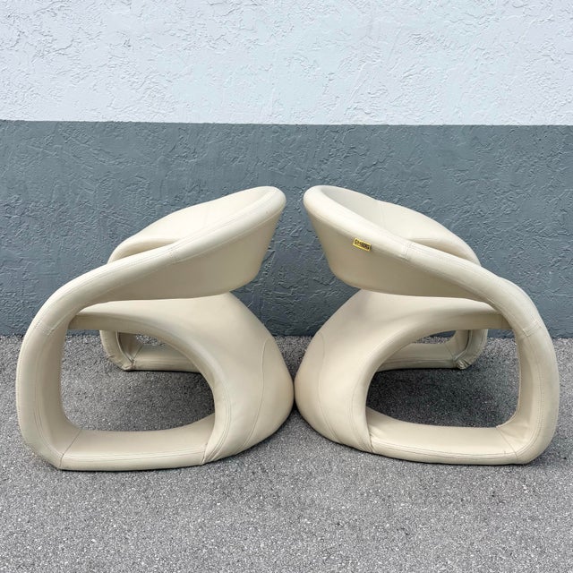 A striking pair of postmodern “tongue” chairs by Cheers, defined by their sculptural, fluid silhouette. Upholstered in...