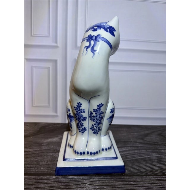 Add timeless Asian-inspired charm to your collection with this **Vintage Blue & White Porcelain Cat Figurine**,...