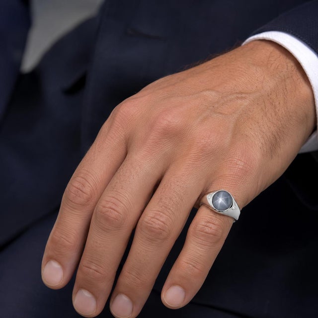 14k white gold ring with an approximately 7.00 carat gray-blue star sapphire and two round diamonds weighing approximately...