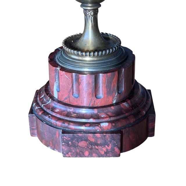 Ornate antique candelabra lamp with eight scrolling candle arms and detailed floral relief. The center features a fluted...