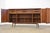 A mid century modern walnut bi-folding door sideboard credenza with adjustable shelves made by Founders Furniture....