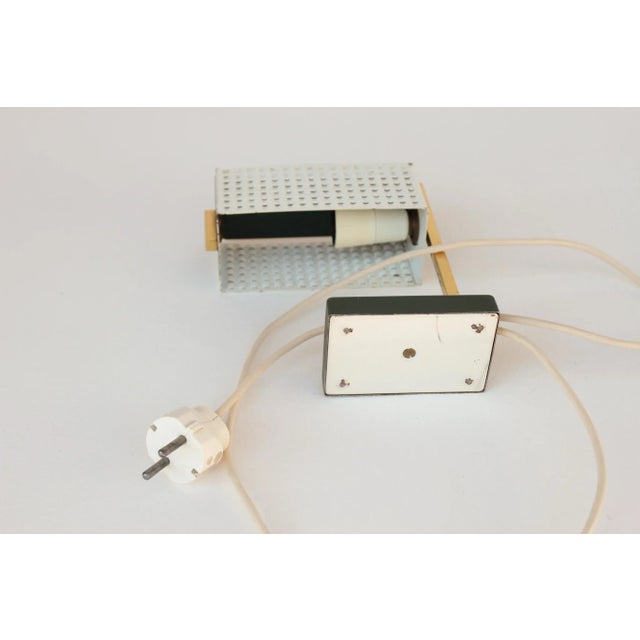 Small modernist table lamp in green and white metal in the style of mathieu matégot, 1950s. made in the 1950s from...