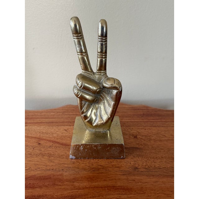 Peace sign hand decor in gold-toned finish. Please see condition details noted. Most items found at Pub & Oasis are...