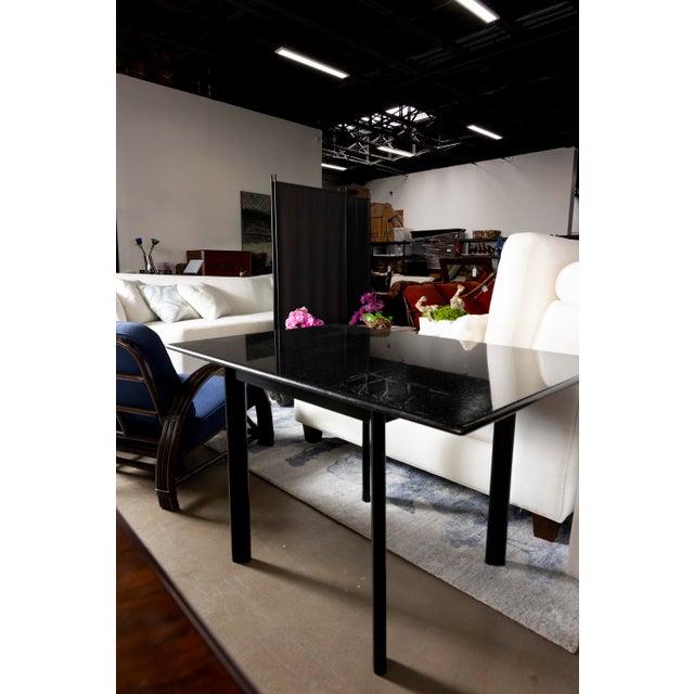 Elegant Knoll black granite table featuring a sleek, minimalist design that complements both modern and classic interiors....