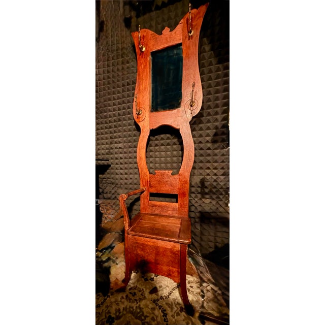 A beautifully crafted antique American oak hall tree w/ mirror, ( Mirror believed to be original ) four original brass...