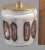 This vintage covered jar by H. Sternberg features a beautiful white and geometric design on a round glass jar. The jar...