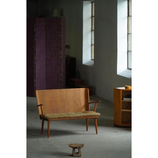 Designed by Göran Malmvall for Karl Andersson & Söner, this iconic two-seat sofa / bench is part of the celebrated Svensk...