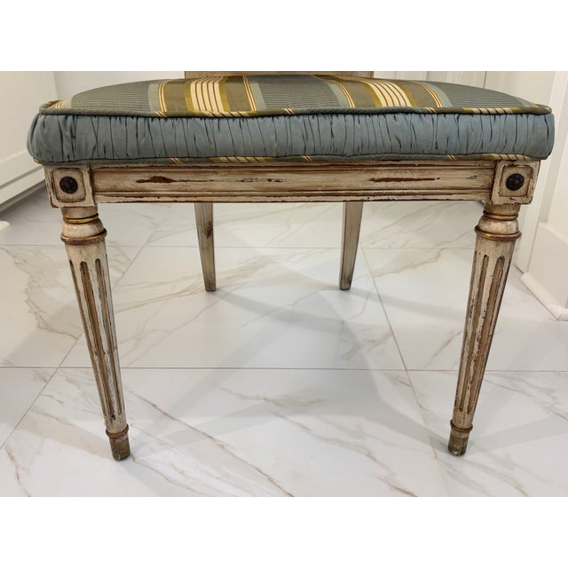 A beautifully proportioned vintage chair executed in the neoclassical taste inspired by 18th Century French XVI design....