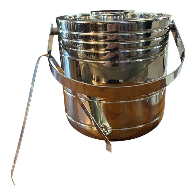 Attractive modern stainless steel ice bucket with tongs. Looks great for display and practical use.