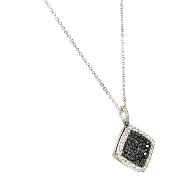 This necklace has Natural Black Diamonds that weigh 0.87 carats and Natural Round Cut Diamonds that weigh 0.40 carats....