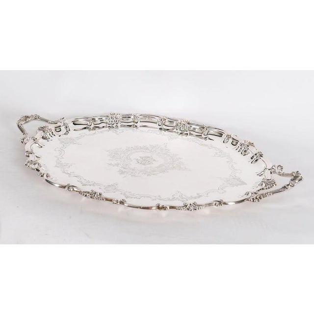 This is a beautiful antique English Victorian Neo-classical oval silver-plated twin handled tray by the renowned...