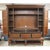 The piece shows a rich mahogany finish with factory distressing that highlights its carved panels and traditional...