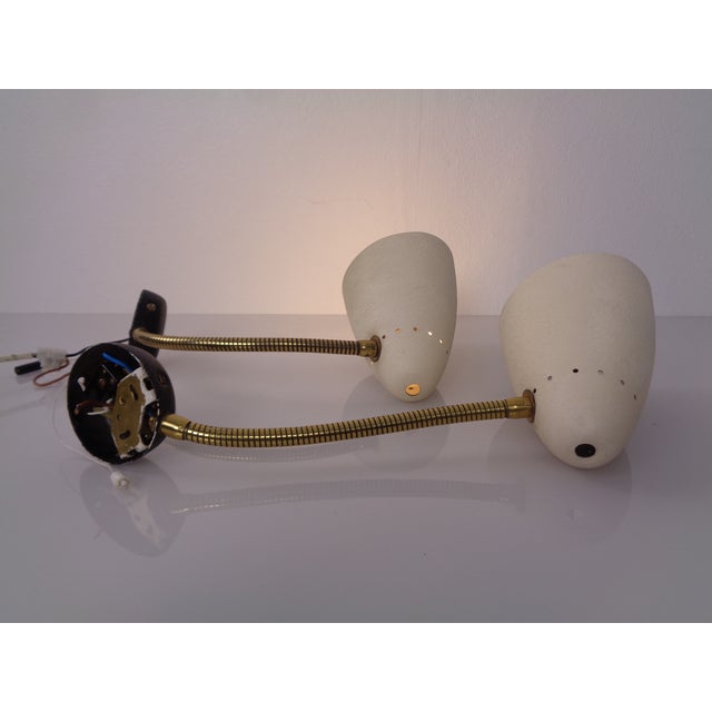 Italian adjustable wall lamps from the 1950s. Both lamps with pull switches. European Plug (up to 250V).The wiring of this...
