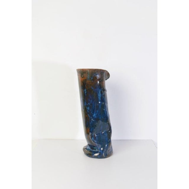A large studio handmade ceramic vase in blue and brown glaze. Marked underneath with the initials A.M. 1969.