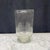 Elegant American hand-blown clear glass hurricane vase with a tall cylindrical form, subtly irregular hand-finished rim...