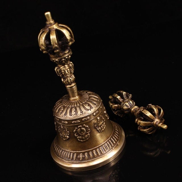 This is a beautifully matched antique brass set consisting of a vajra (dorje) and a ghanta (bell), traditional ritual...