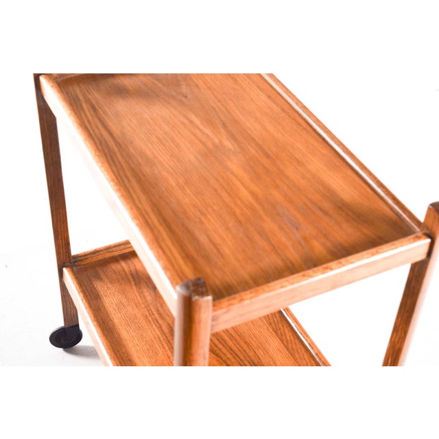 This is a lovely vintage oak tea cart. Its wheels roll smoothly on the ground and have a simple style. This cart probably...