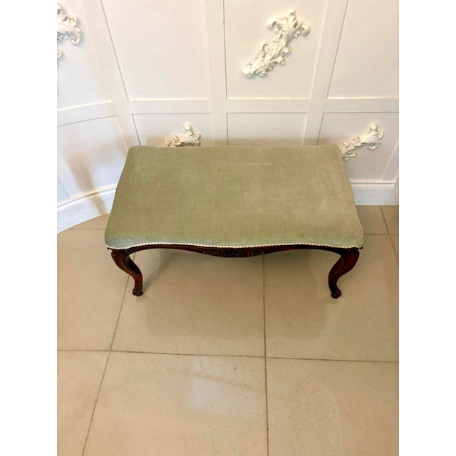 A beautifully proportioned and large example of a Victorian carved walnut stool. The walnut frame is finely shaped with...