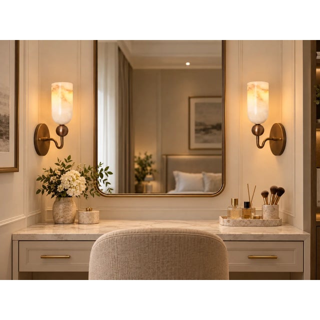 Introduce a warm, sculptural accent to your interior with this handcrafted brass wall sconce, featuring a softly curved...