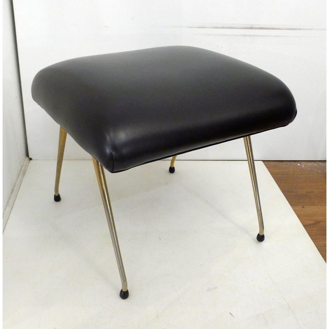 Large mid-century footstool/ottoman/stool from the 1960s. Features a compass-style base in gold-tone tubular metal (with...