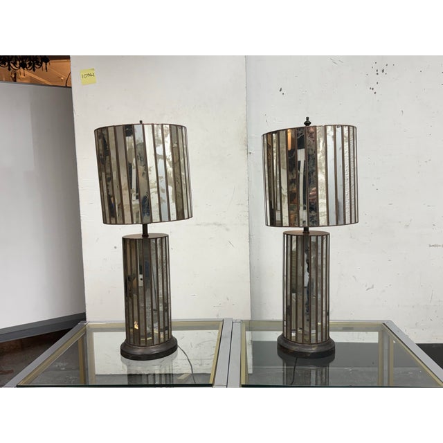 Design Plus Gallery presents a Pair of Vintage Antiqued Mirror + Bronze-Tone Metal Table Lamps. Sourced by the Design Team...