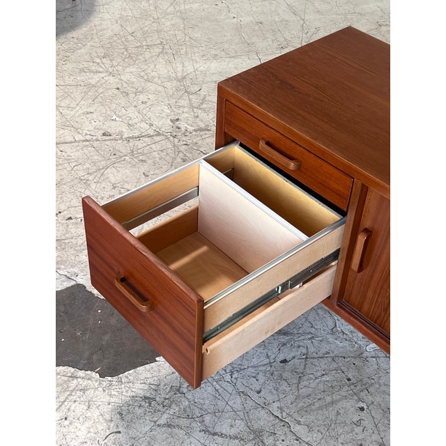Newly refinished Danish teak credenza, featuring beautiful teak grain, filing drawers as well as open cabinetry, and...