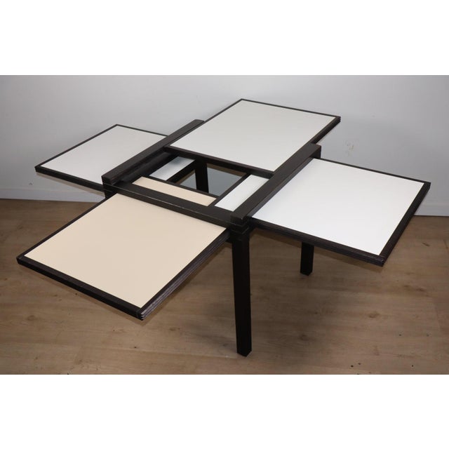 Elegant and ingenious, this dining table designed by Bernard Vuarnesson captivates with its architectural design and...