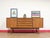 A beautiful credenza in the style of Austinsuite, this Mid Century Modern Vintage Teak Credenza Sideboard showcases the...