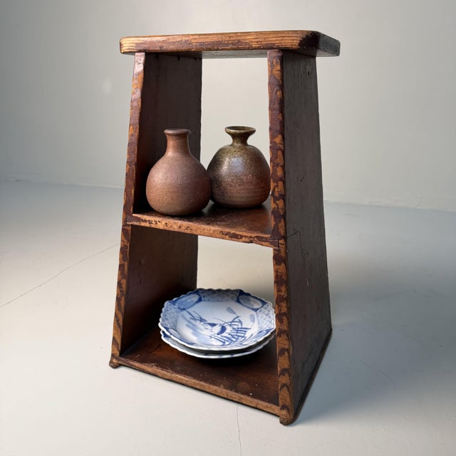 This traditional Japanese fumidai step stool has a clean, graphic silhouette with slightly tapered side panels and an open...