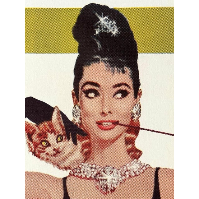 An iconic Breakfast at Tiffany’s movie poster featuring Audrey Hepburn, measuring approximately 40” × 27”. Printed on...