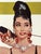 An iconic Breakfast at Tiffany’s movie poster featuring Audrey Hepburn, measuring approximately 40” × 27”. Printed on...