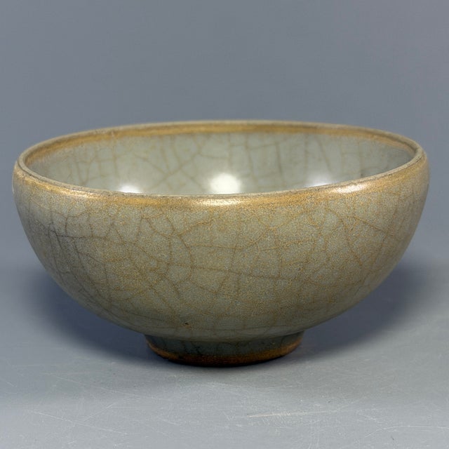 Fine antique Chinese celadon bowl. Generous rounded deep‑bowl form, entirely covered in natural crackled celadon glaze, a...