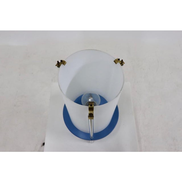 Playful table lamp designed by the Italian architect Umberto Riva for Fontana Arte in the 1980s. The lamp has an opaline...