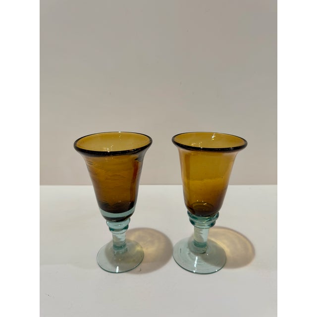 Charming pair of vintage art glass goblets with amber bowls and blue-green stems and bases. Both have a softly flared form...