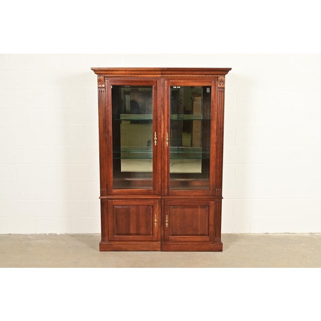 A gorgeous French Regency Louis XVI style two-piece lighted bookcase, display cabinet, or dining cabinet By Ethan Allen...