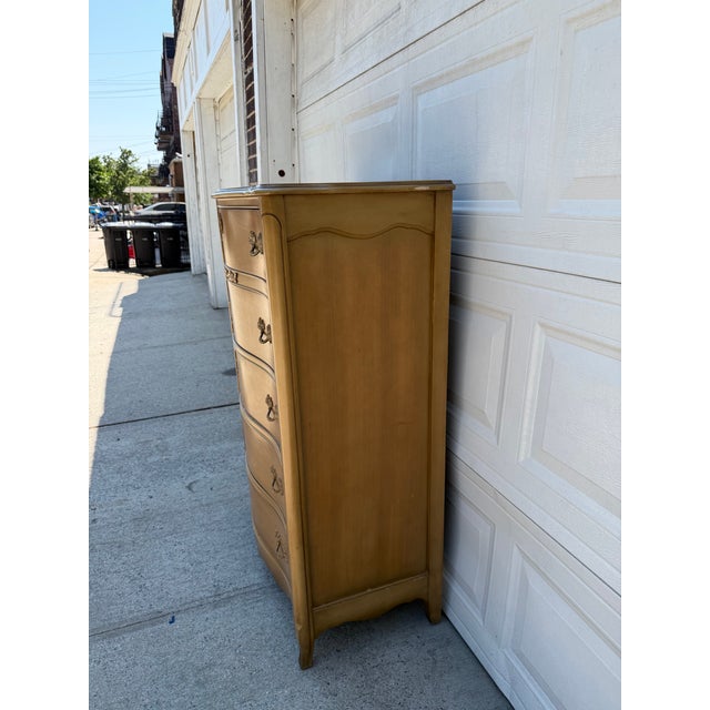 We have an absolutely stunning vintage French Provincial tallboy dresser for sale. It features beautiful serpentine drawer...