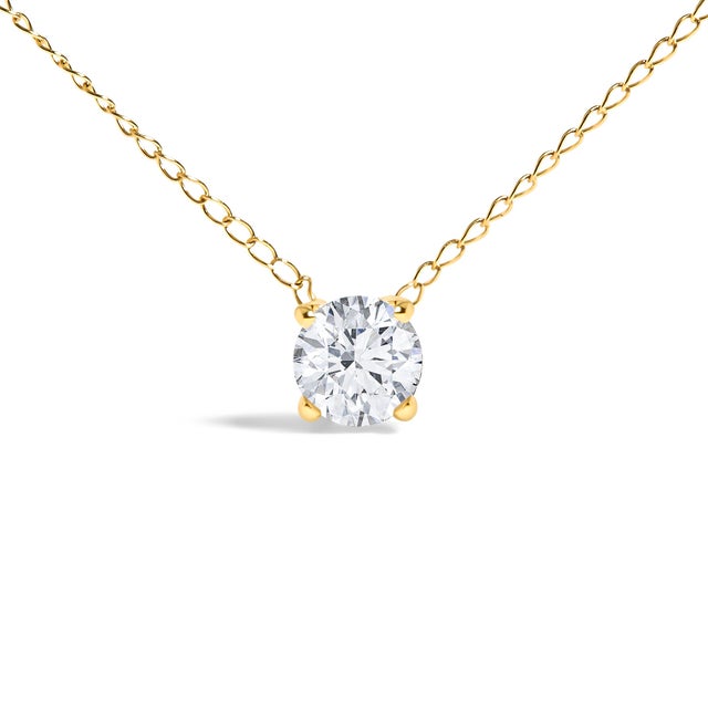 Immerse yourself in the pure elegance of this exquisite 14K yellow gold pendant necklace, where simplicity meets...